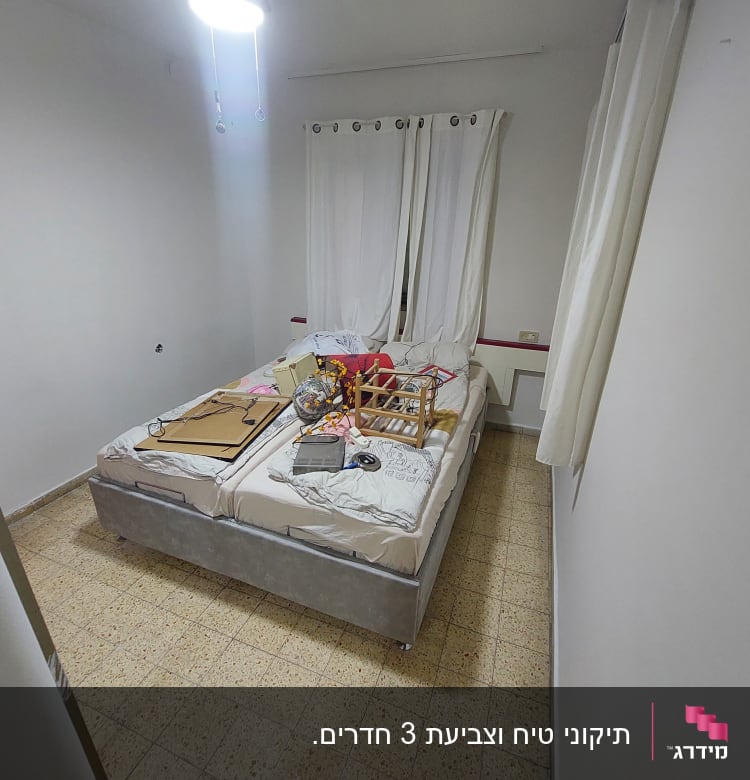 חדר עם מיטה, חפצים וציוד על המיטה